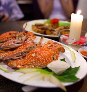 a plate of seafood on a table with a candle