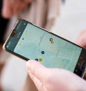 a person holding a cell phone with a map