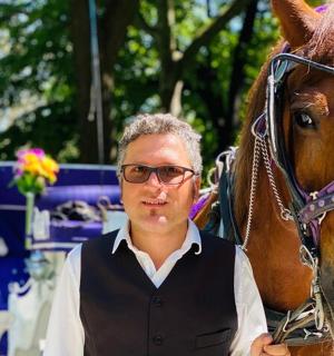 a man standing next to a brown horse
