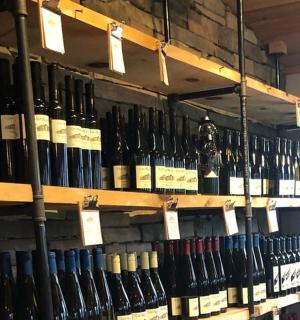 a bunch of bottles of wine are on shelves
