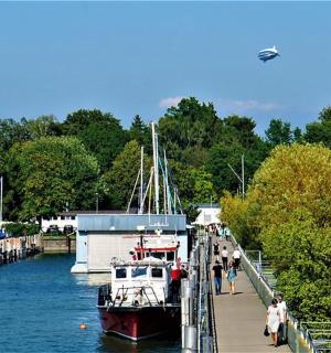 a boat is docked next to a dock with people on it
