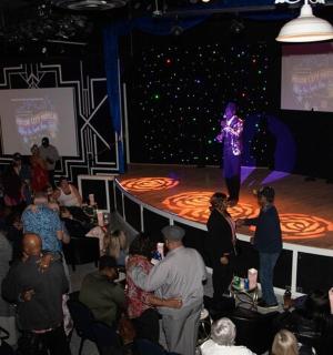 a woman standing on a stage in front of a crowd