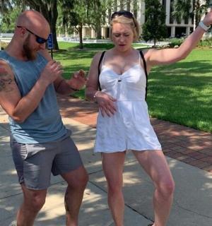 a man and a woman standing on a sidewalk