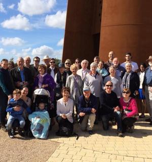 a group of people posing for a picture in front of a building
