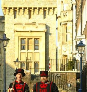 two men in uniform standing in front of a building