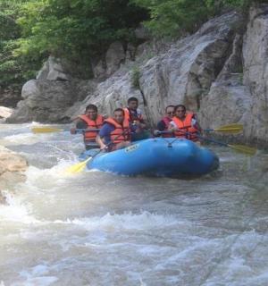a group of people in a raft in a river