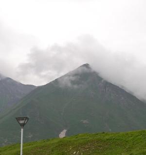 a mountain with a street light in front of it