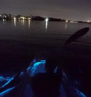 a boat on the shore of a lake at night