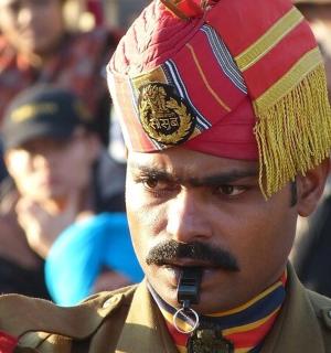 a man wearing a turban and talking on a cell phone