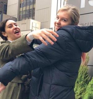 a man hugging a woman in front of a building