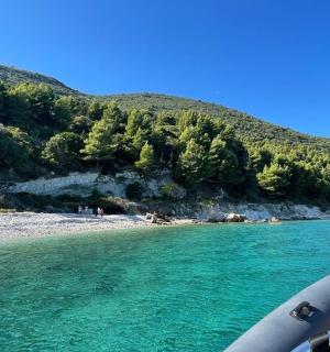 a boat in the water next to a beach