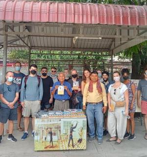 a group of people posing for a picture at a bus stop