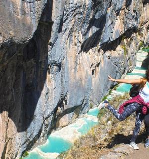 two people posing for a picture on the side of a mountain