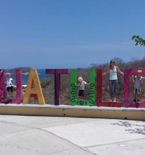 a group of people standing in front of a sign