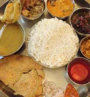 a tray of food with rice and different types of food