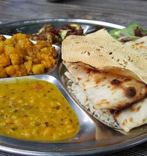 a plate of food with a plate of indian food
