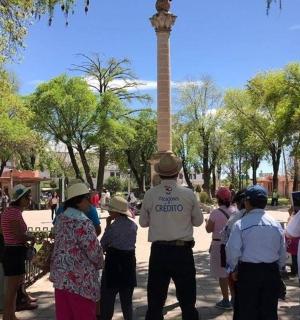 a group of people standing in front of a obelisk