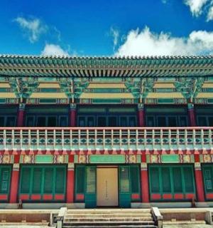 a large building with green and red doors on it