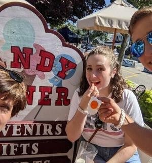 a group of people standing in front of a sign