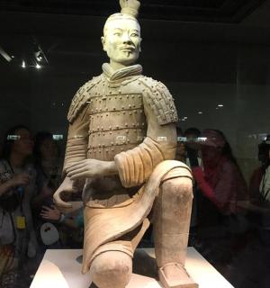 a group of people looking at a statue of a man