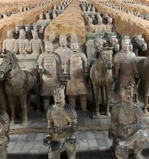 a group of statues of men and horses on display