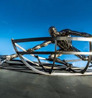 a metal sculpture of two birds on top of a roof