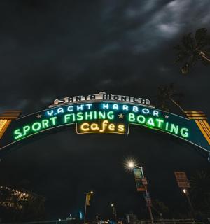 a sign for a sports betting and poaching cafe at night