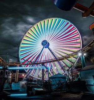a large ferris wheel at a carnival at night