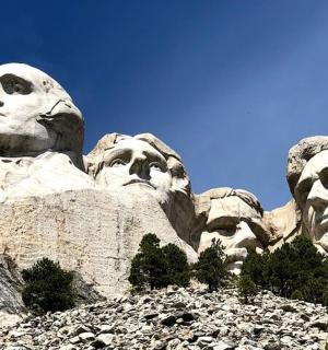 socha tří tváří na vrcholu hory