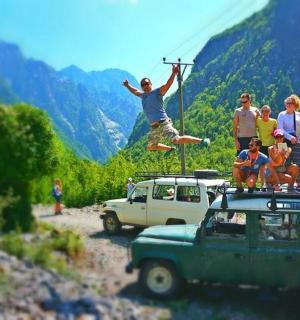 a group of people standing on the top of a car
