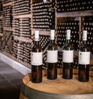 a group of wine bottles sitting on a barrel