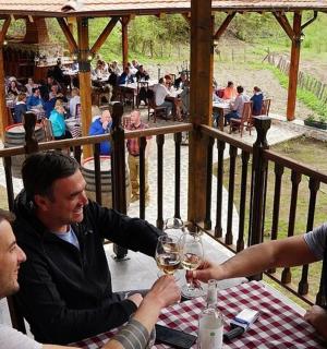 a group of men sitting at a table with wine glasses