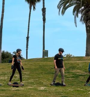 a group of people riding skateboards in a park