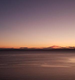 a view of the ocean at sunset