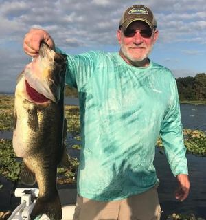 a man holding a large fish in his hand