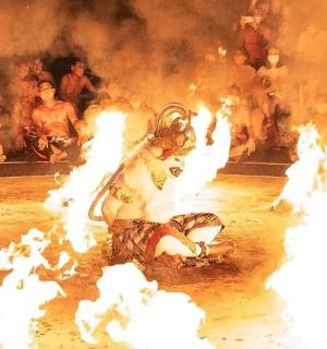 a man is laying on the ground in front of fire