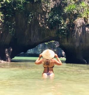 a woman in the water with a straw hat