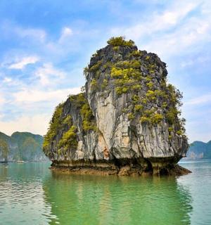 a large rock in the middle of the water