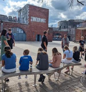a group of children sitting on a bench