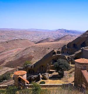 a view of the desert from a mountain with buildings