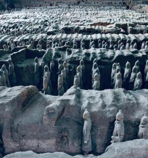 a large group of statues on a rock formation