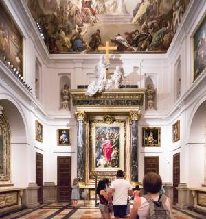 a group of people looking at a painting in the vatican museums