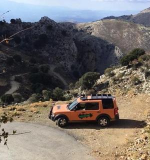 一辆橙色卡车沿着土路行驶