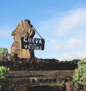 a sign in front of a rock formation