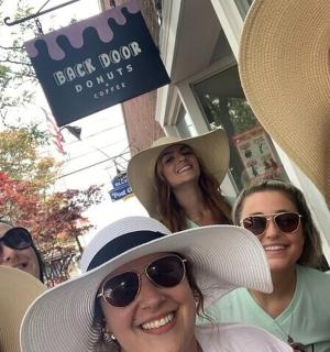 a group of women wearing hats posing for a picture