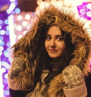 a woman wearing a coat and a fur hood