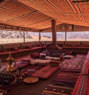 a large room with red pillows and tables in a building