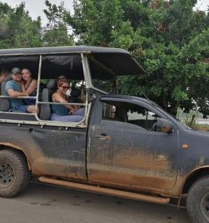a group of people sitting in the back of a truck