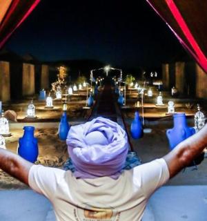 a person with their arms up in front of a curtain