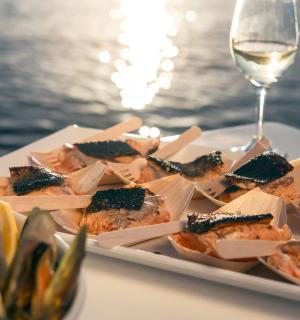 a plate of food on a table with a glass of wine